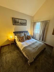 a bedroom with a bed and a window at Kexby House in York