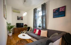 a living room with a couch and a table at Awesome Home In Split in Split
