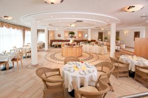 a dining room with white tables and chairs and tablesktop at Hotel Barbarossa in Düsseldorf