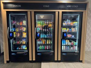 two refrigerators in a store with drinks and sodas at Days Inn & Suites by Wyndham Wausau in Wausau