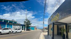 a street in a town with cars parked on the street at Hotel Paraiso Natal - EXPRESS in Natal