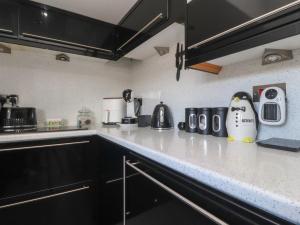 a kitchen with a penguin figurine sitting on the counter at 17 Alexandra Court in Skipton +14 photos