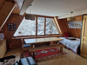 a dining room with a table and a window at le chalet pointu de capucine in Bourg-Saint-Maurice +43 photos