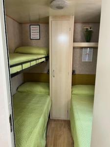 a small room with two bunk beds in it at Bungalow 477 Colibrì in Ameglia +32 photos
