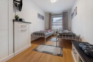 a living room with two beds and a window at Ferienhaus Am Waldrand in Wietze