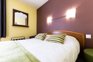 Postel nebo postele na pokoji v ubytování Hotel Cheval De Bronze