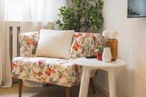 a living room with a chair and a table at Black Forest Flower Apartment in Bad Wildbad