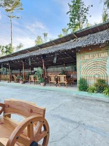 a bench sitting in front of a restaurant at Balay Sa Uma in Iloilo City