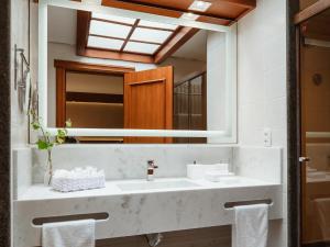 a bathroom with a sink and a mirror at Kurotel Centro Contemporâneo de Saúde e Bem Estar in Gramado