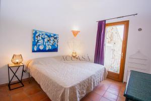 een slaapkamer met een bed en een raam bij Villa Mare è Macchia Accasà in Bonifacio