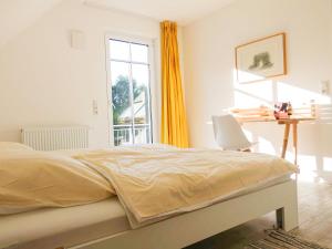 Un dormitorio con una cama y un escritorio y una ventana. en Körkhus, en Dorf Körkwitz