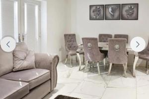a living room with a couch and a table and chairs at The hawthorns large detached 3 bedroom family home in Seaham +33 photos