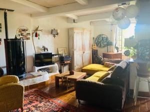 a living room with a couch and a fireplace at Maison de famille en Provence in Rognes