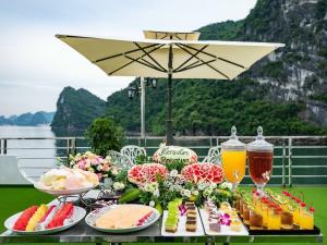 a table with food and drinks on top at Halong Collection Of The Sea Cruises in Ha Long +26 photos