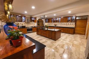 a large kitchen with wooden cabinets and a large island at Asante Karibu House in Arusha