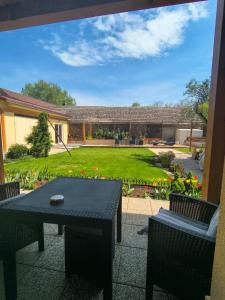 a patio with a table and chairs and a yard at apartmán 1kk Zlámanka in Kroměříž