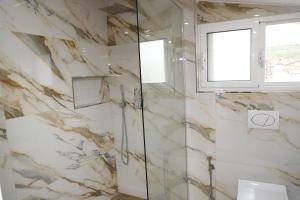 a bathroom with a marble wall at Guesthouse Aloe in Berat +19 photos