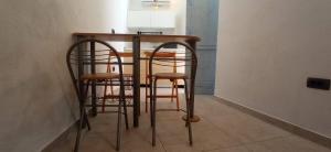 a table and stools with a lamp on top of it at Entrata Pirano in Piran