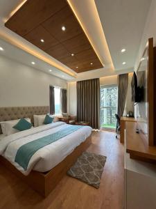 a bedroom with a large bed and a large window at Cocoon A Luxury BnB in Shimla