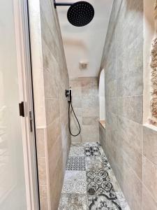 a bathroom with a shower and a tile floor at Lo Juso in Putignano +11 photos