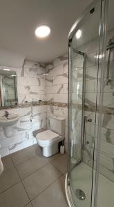 a bathroom with a toilet and a glass shower at SEASIDE HOUSE 12 Shore Street, Avoch IV9 8QD in Avoch +16 photos