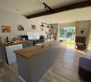 a kitchen with a sink and a counter top at La Bergerie Luxury cottage and pool on eco-friendly micro-farm in Duravel