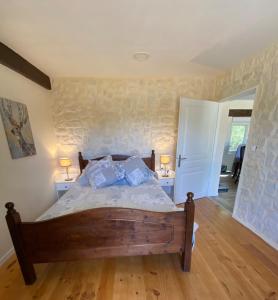 a bedroom with a bed and two lamps on two tables at La Bergerie Luxury cottage and pool on eco-friendly micro-farm in Duravel +69 photos