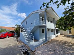 a white building with a staircase on the side of it at Seru Coral Resort Appartement 188 in Willemstad