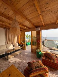 a living room with a couch and a table at Taghazout Life in Taghazout
