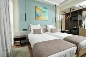 Postel nebo postele na pokoji v ubytování NJ Hotel Rabat + 37 fotografií
