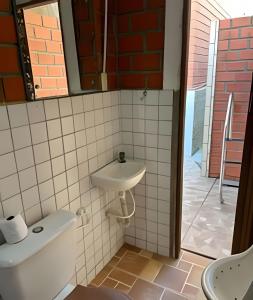a bathroom with a sink and a toilet at Casa com piscina in Gravatá +20 photos