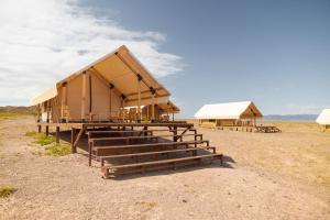 a group of buildings in the middle of a field at Charyn Canyon Camp in Kökpek