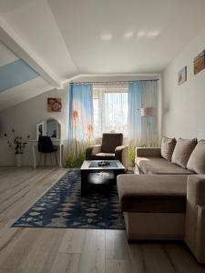 a living room with a couch and a table at Marino in Kołobrzeg