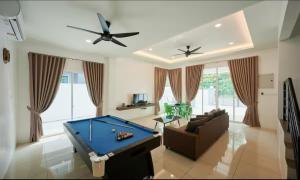 a living room with a pool table and a ceiling fan at 110 Home Sleep Home Kuah Langkawi in Kuah