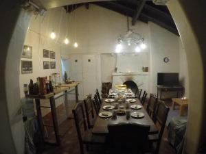 a large dining room with a long table and chairs at Calmuco Shelter in Coehue-Có +22 photos