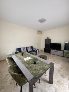 a living room with a table and a couch at Alba Apartment in Riccione