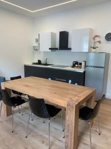 a kitchen with a wooden table and chairs at La casa di Elena in Valdobbiadene