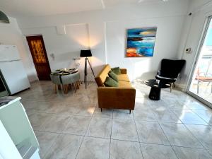 a living room with a couch and a table at Casa Sea Breeze in Larnaca