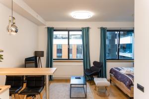 a bedroom with a bed and a desk and chairs at Apartment Atrium- A blok in Novi Beograd