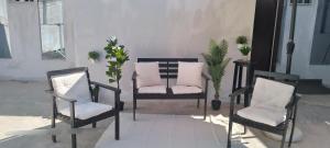 two chairs and a pillow on a porch at Spacious seaside house in Nea Makri in Nea Makri