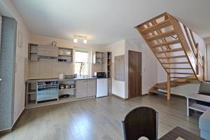 a kitchen with a spiral staircase in a room at Domki TERRA in Debina +13 photos