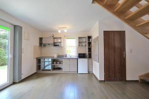 an open kitchen with a counter and a refrigerator at Domki TERRA in Debina