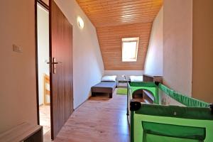 a hallway with a door and a chair in a room at Domki TERRA in Debina