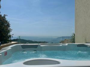 a jacuzzi tub with a view of the ocean at Luxury Adria Sea City & Whirpool, Mountain View Apartment in Makarska +56 photos