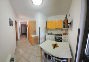 a kitchen with a table with a slice of pizza on it at Residenza Giscor in Gasponi +23 photos