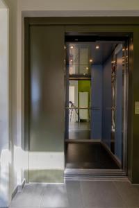 an entrance to a building with a large glass door at Penthouse bij Leopoldpark in Ostend