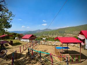 a playground with a bunch of play equipment at The Chakras Valley Homestay in Binsar