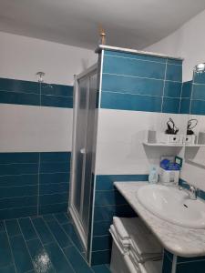 a blue and white bathroom with a sink and a shower at Casa vacanze Manuel, da Maruzzella in Procida +8 photos