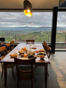 a table with food on it in a room with a view at Panoradome - Avec table d'hôtes sur réservation - Climatisé in Saint-Maurice +13 photos