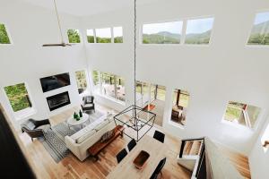 a large living room with white walls and windows at Serenity Now 4br Fall Retreat Deck Fireplace in Young Harris
